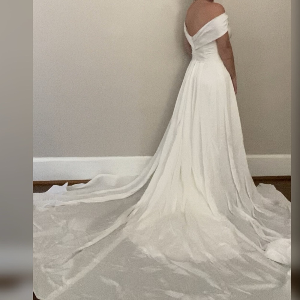 Wedding dress with long overskirt train